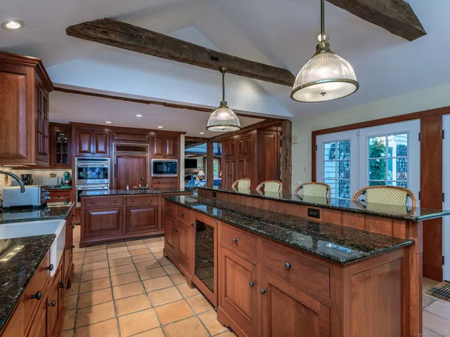 a kitchen with granite countertop a sink and a stove