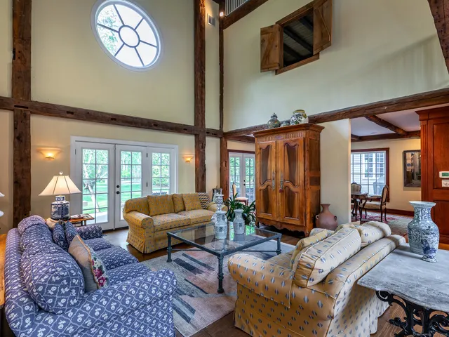 a living room with furniture a fireplace and a large window