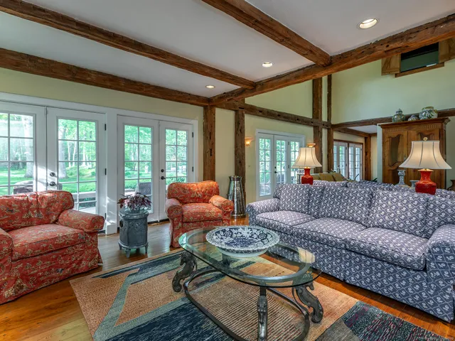 a living room with furniture and a floor to ceiling window