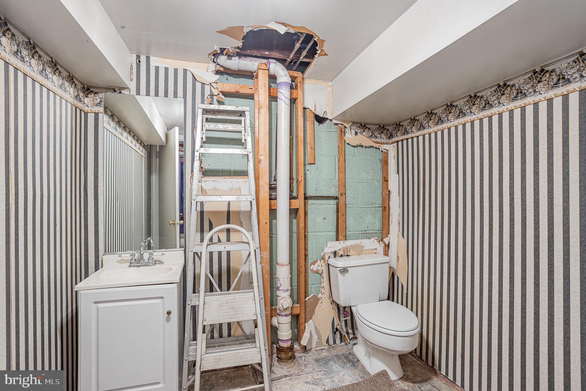1408 Locust Street Curtis Bay, MD 21226 - Photo 22 of 25 a bathroom with a toilet sink shower and mirror