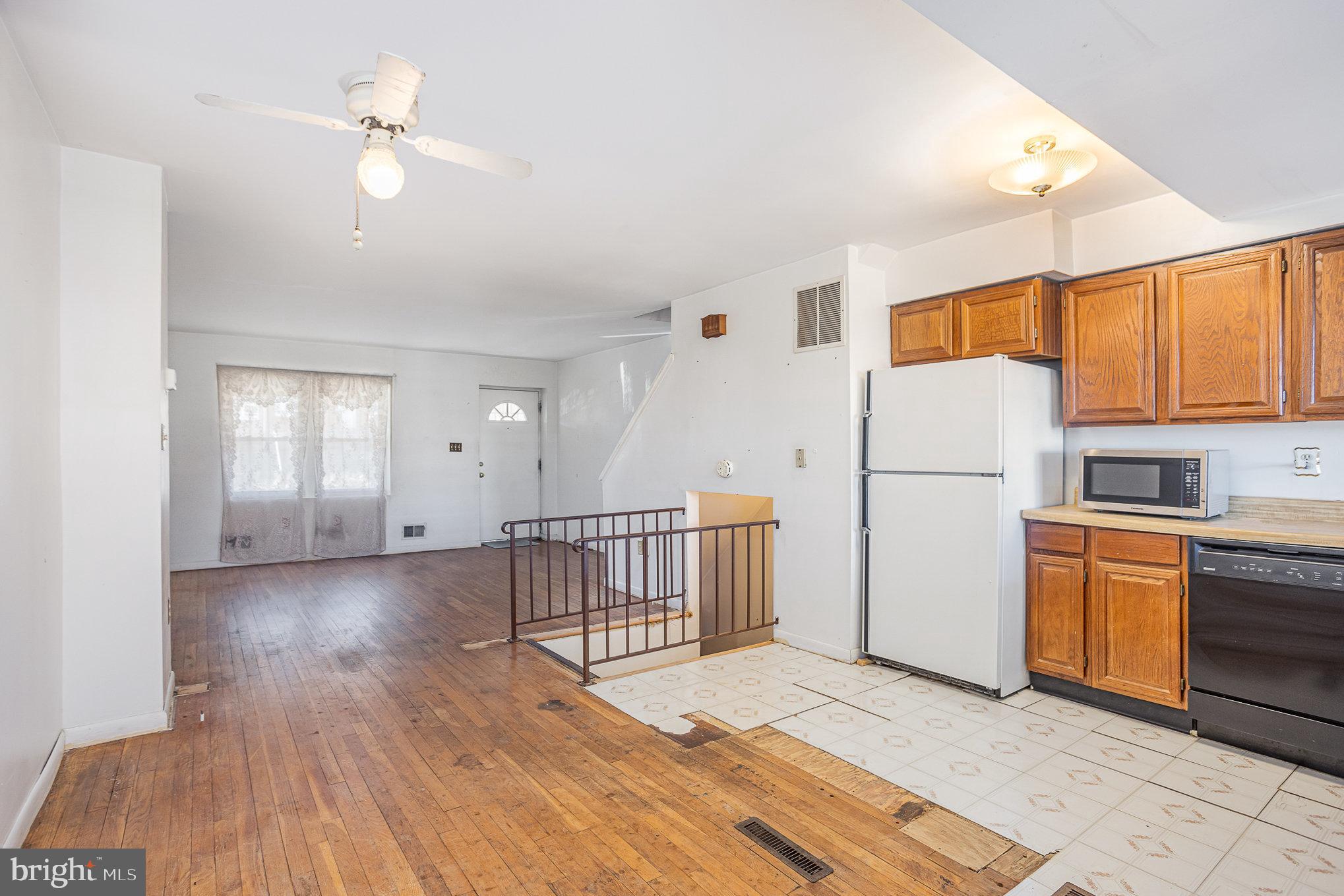 1408 Locust Street Curtis Bay, MD 21226 - Photo 7 of 25 a view of a kitchen with a sink cabinets and wooden floor