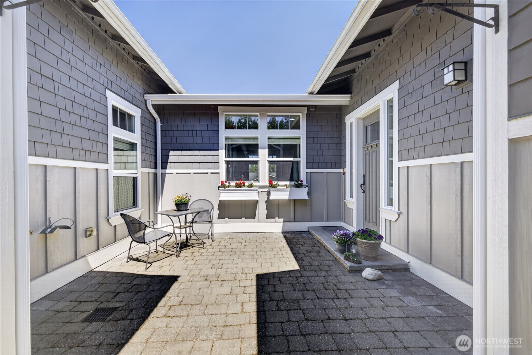 1908 29th Place Anacortes, WA 98221 - Photo 2 of 40 a view of a patio with table and chairs and wooden floor