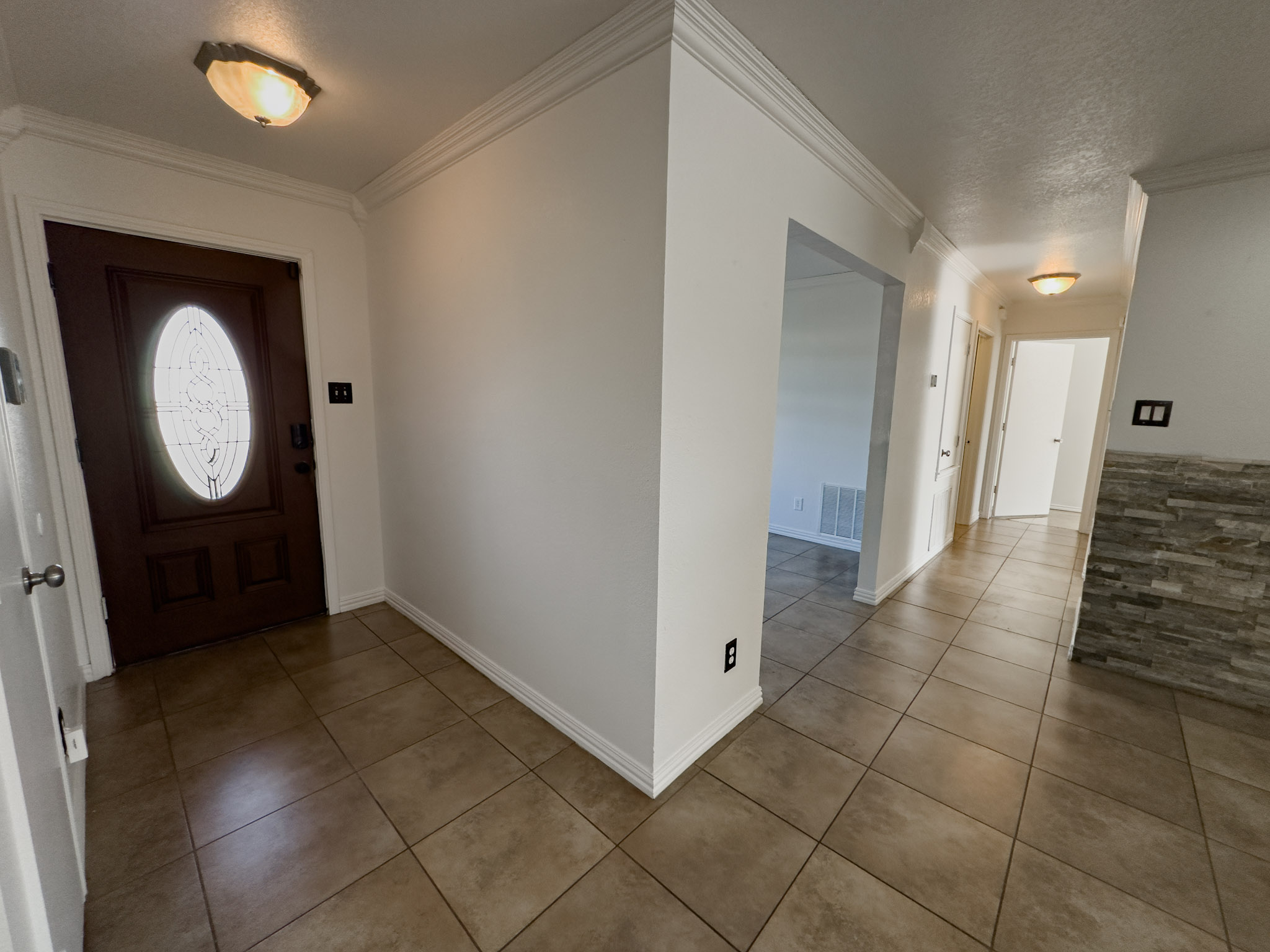 a view of a hallway with entryway door