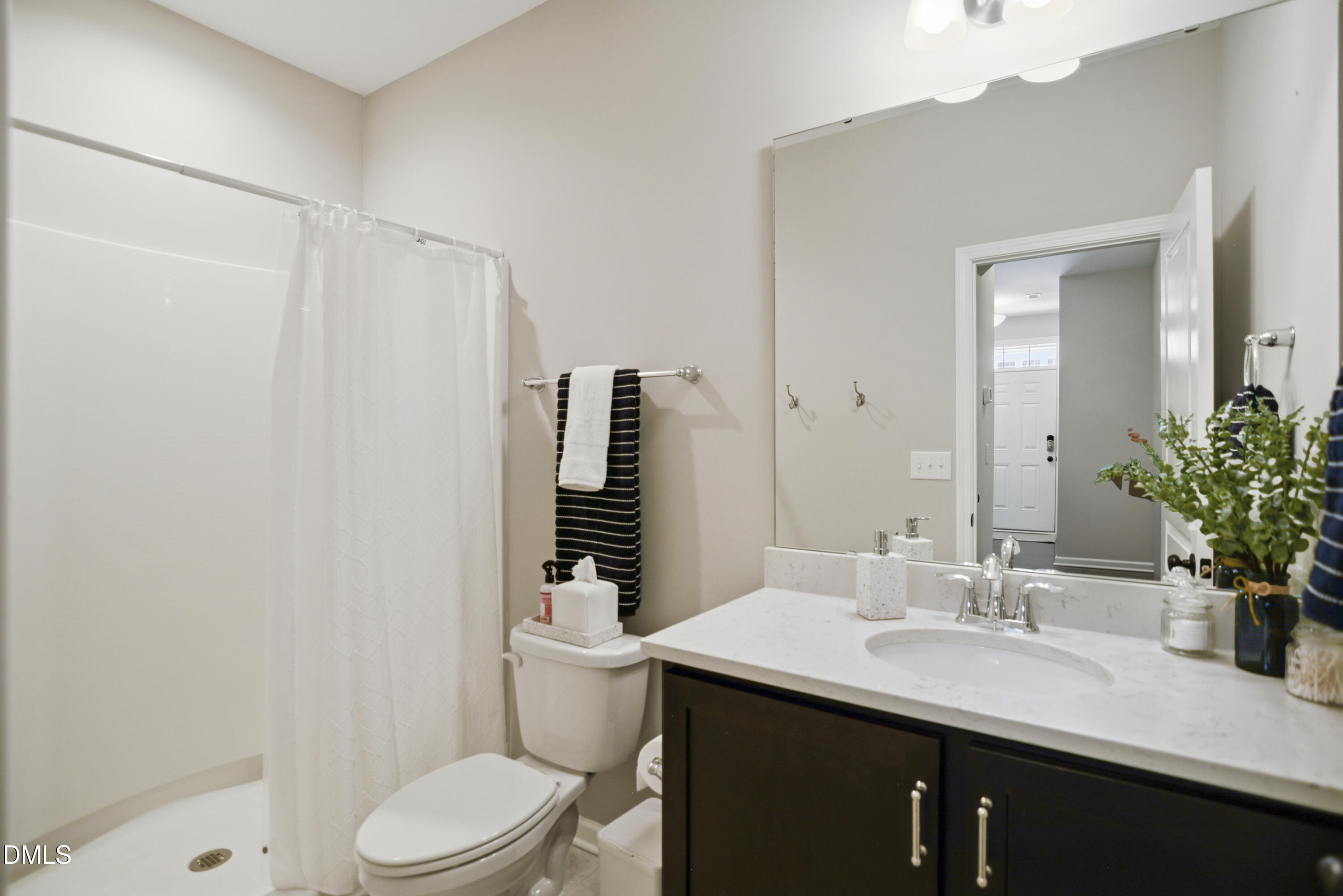 5916 Giddings Street Raleigh, NC 27616 - Photo 28 of 49 a bathroom with a sink a toilet a mirror and shower