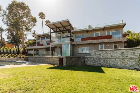a front view of a house with swimming pool