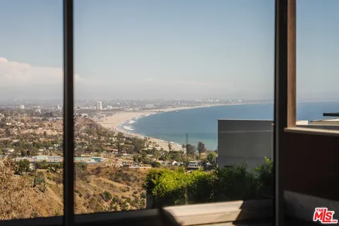 a reading room with furniture and a potted plant