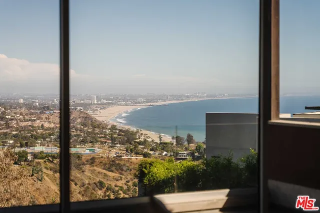 a reading room with furniture and a potted plant