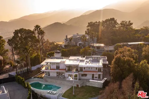 a view of a terrace with a water fall and mountain view