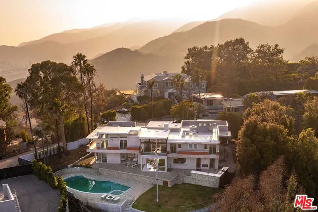 a view of a terrace with a water fall and mountain view