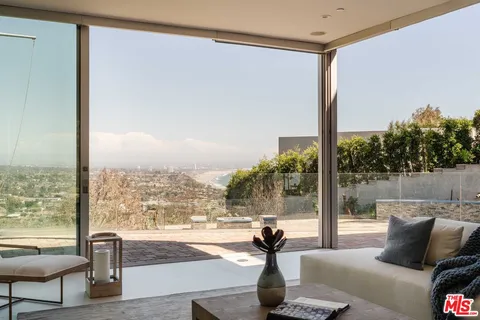 a living room with couch and a floor to ceiling window