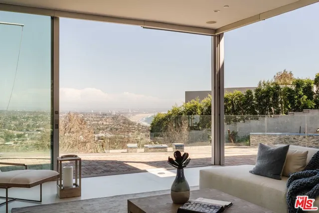 a living room with couch and a floor to ceiling window