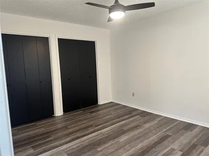 a kitchen with a refrigerator a sink and wooden floor