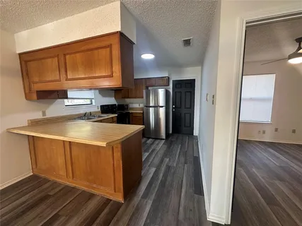 a large kitchen with a sink and cabinets