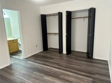 a view of a walk in closet with wooden floor