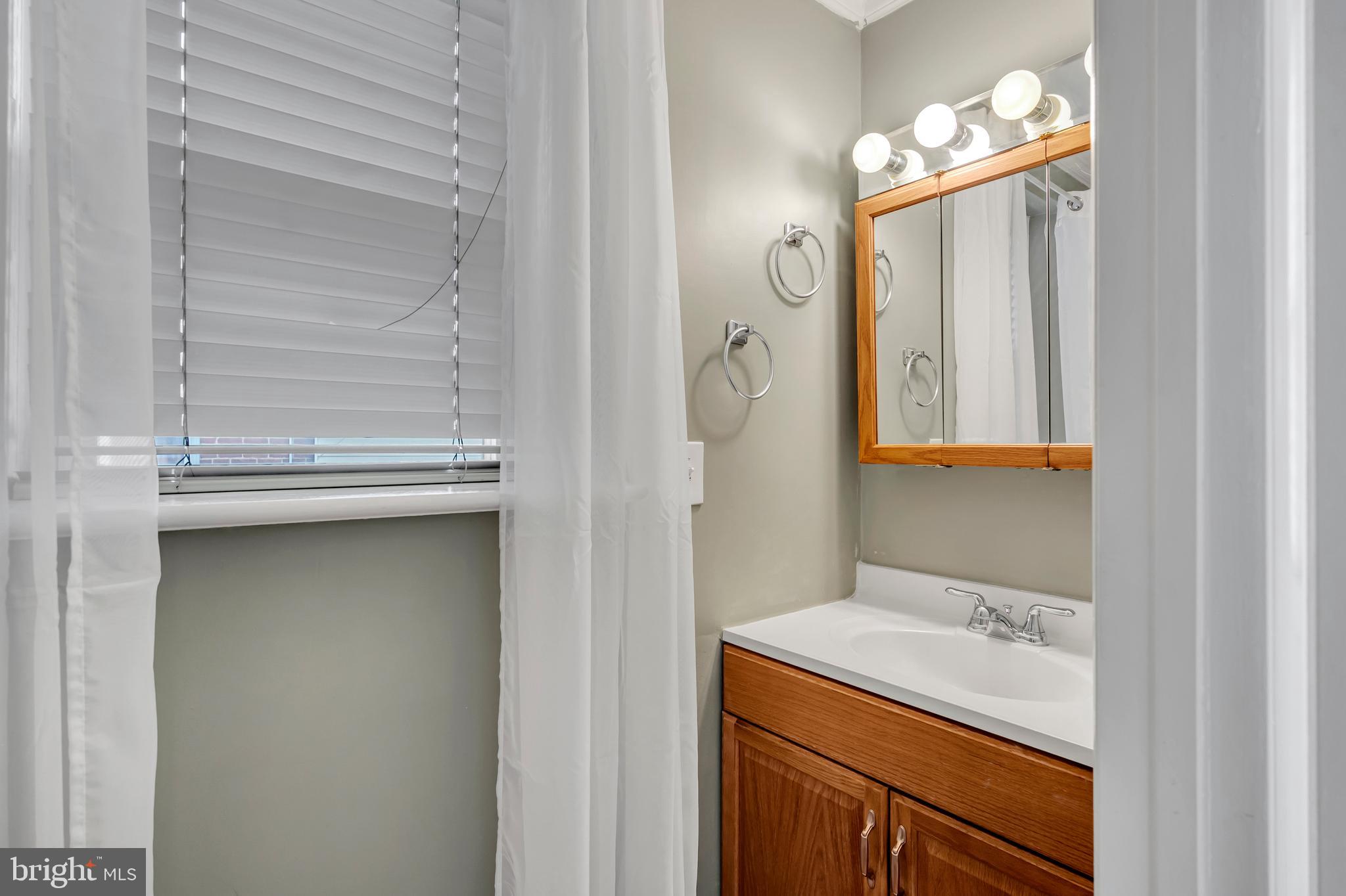 29 School Lane Springfield, PA 19064 - Photo 12 of 29 a bathroom with a sink and mirror