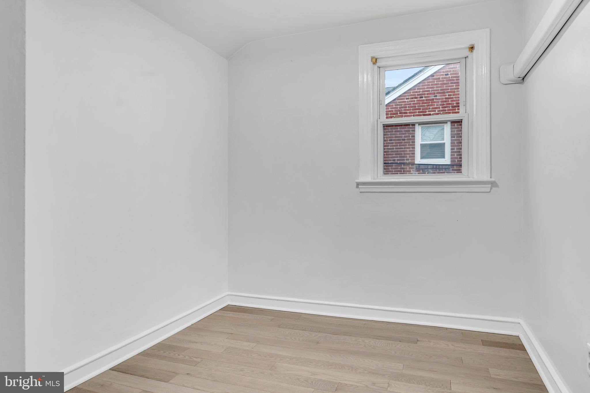29 School Lane Springfield, PA 19064 - Photo 15 of 29 a view of an empty room with wooden floor and a window