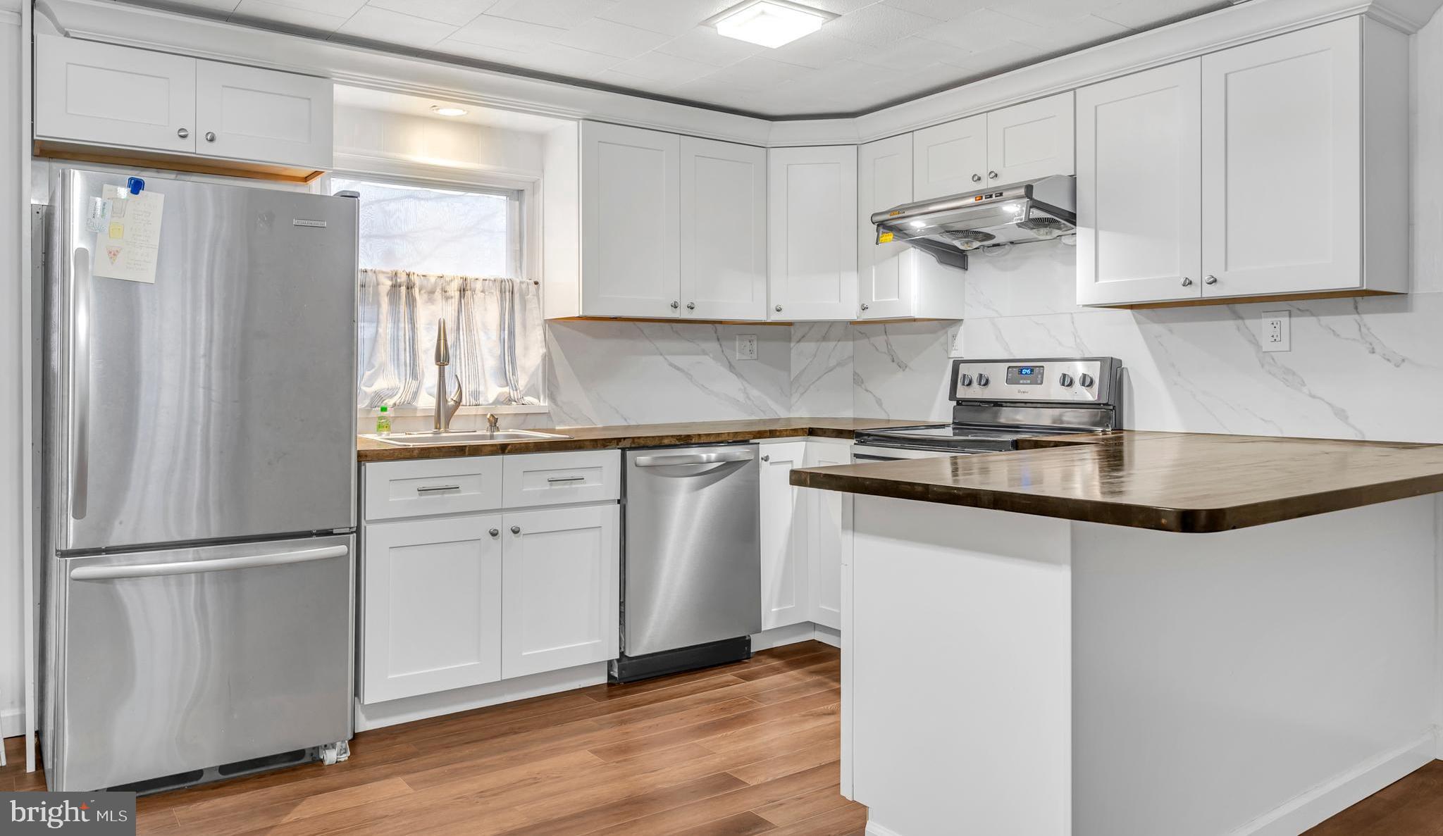 29 School Lane Springfield, PA 19064 - Photo 7 of 29 a kitchen with a refrigerator sink and cabinets