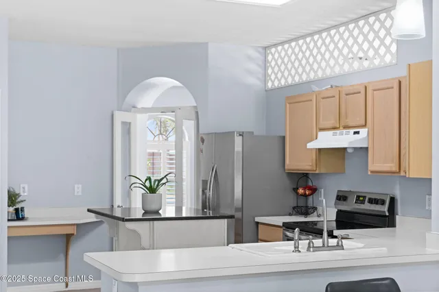 a view of a kitchen with a stove and a sink