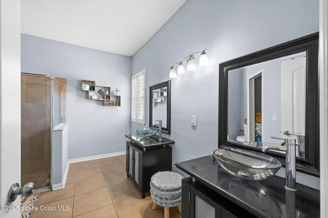 a bathroom with a granite countertop sink and a mirror with toilet