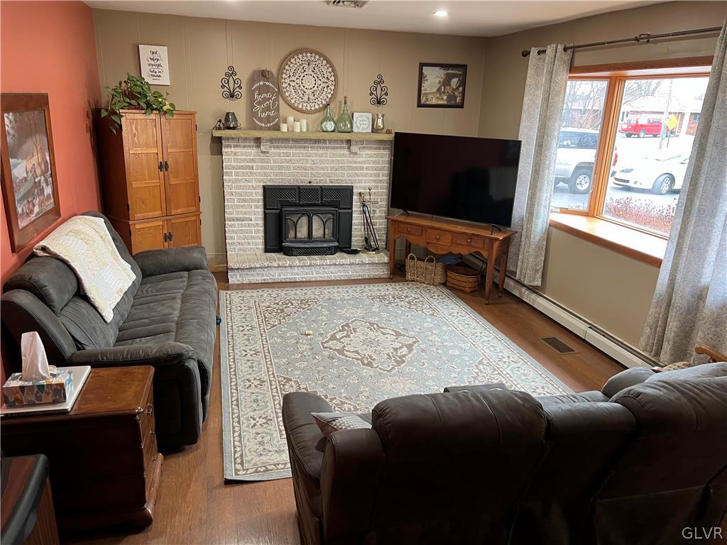 684 Williams Road Nazareth, PA 18064 - Photo 7 of 28 a living room with furniture a flat screen tv and a fireplace