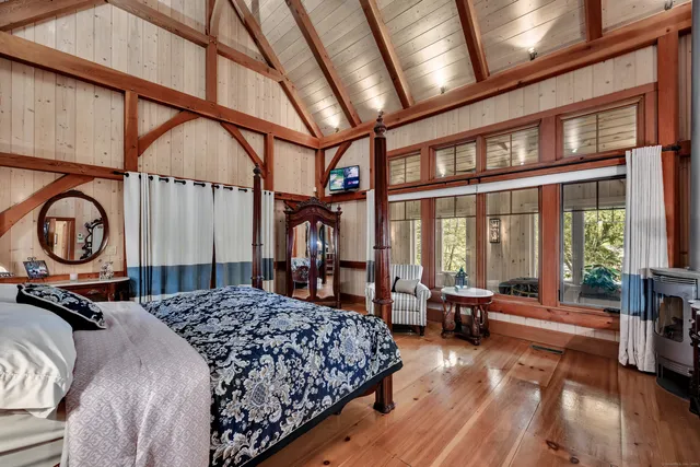 a bedroom with bed and a large window