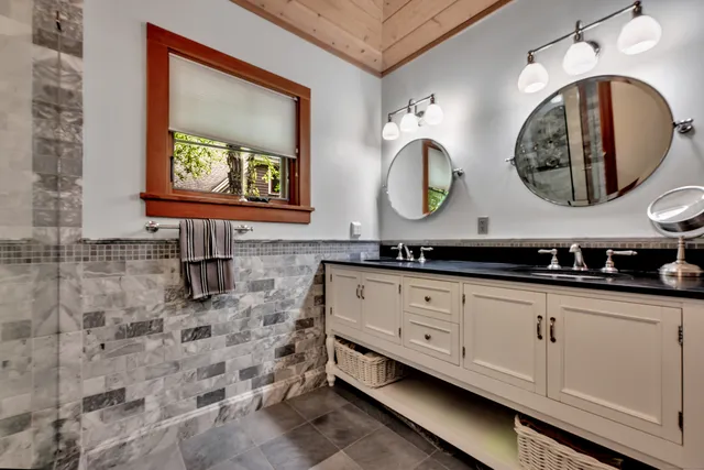 a bathroom with a double vanity sink and a mirror