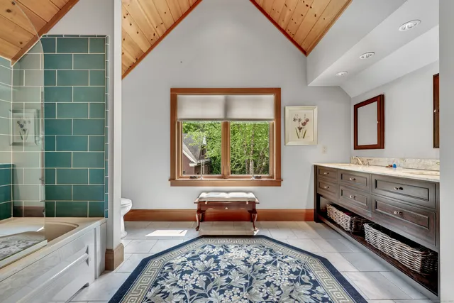 a spacious bathroom with a double vanity sink a mirror and a bathtub
