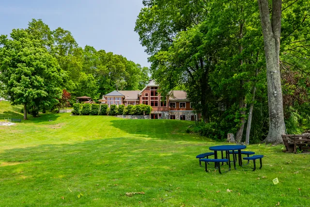 a view of a patio with a table chairs and a backyard