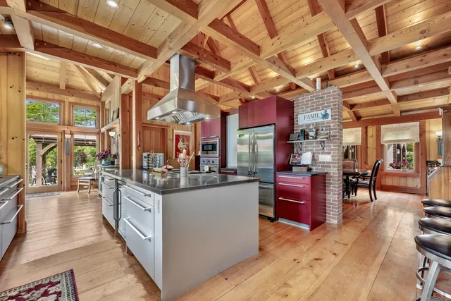 a view of a kitchen with stainless steel appliances granite countertop a stove and cabinets
