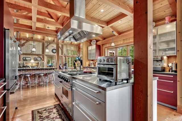 a kitchen with stainless steel appliances granite countertop a stove and a refrigerator
