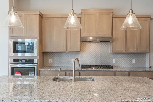 a kitchen with sink and refrigerator