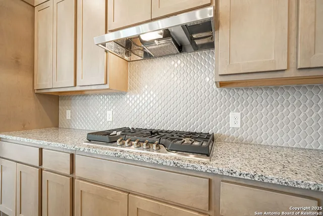 a kitchen with a stove and a cabinets