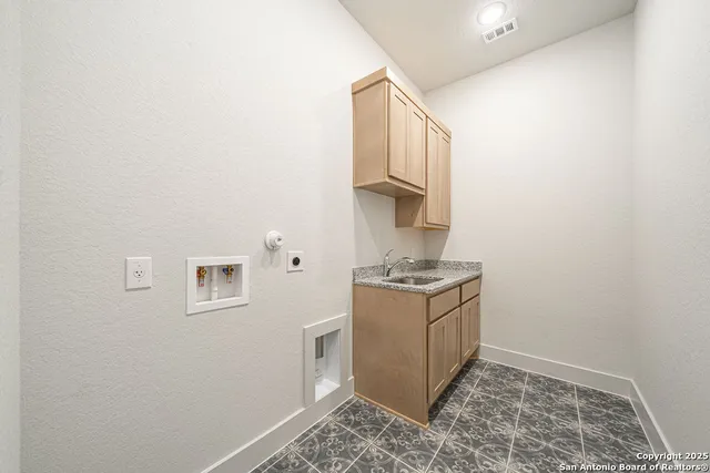 a kitchen with stainless steel appliances granite countertop a sink and a stove