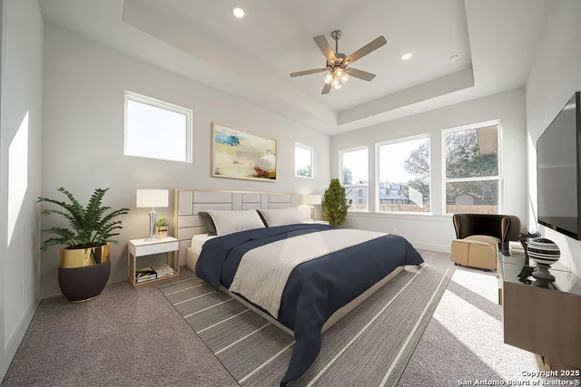 a bedroom with a bed a chandelier and a couch