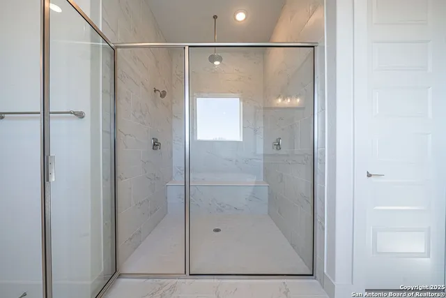 a bathroom with a shower and a sink