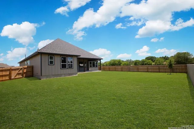 a view of a house with a backyard