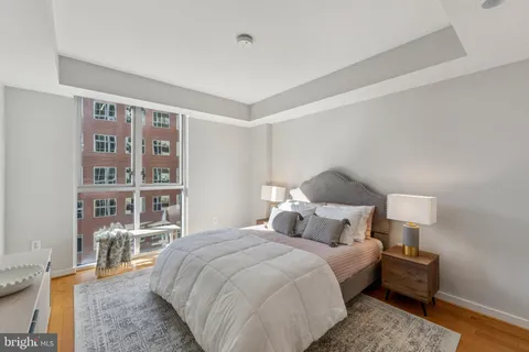 a bedroom with a bed and a book shelf