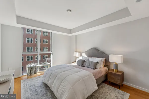 a bedroom with a bed and a book shelf