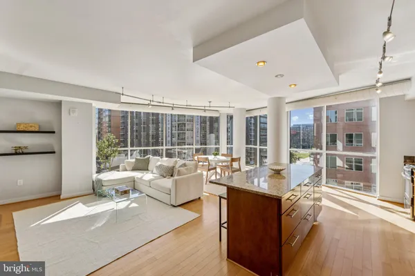 a living room with furniture and large windows