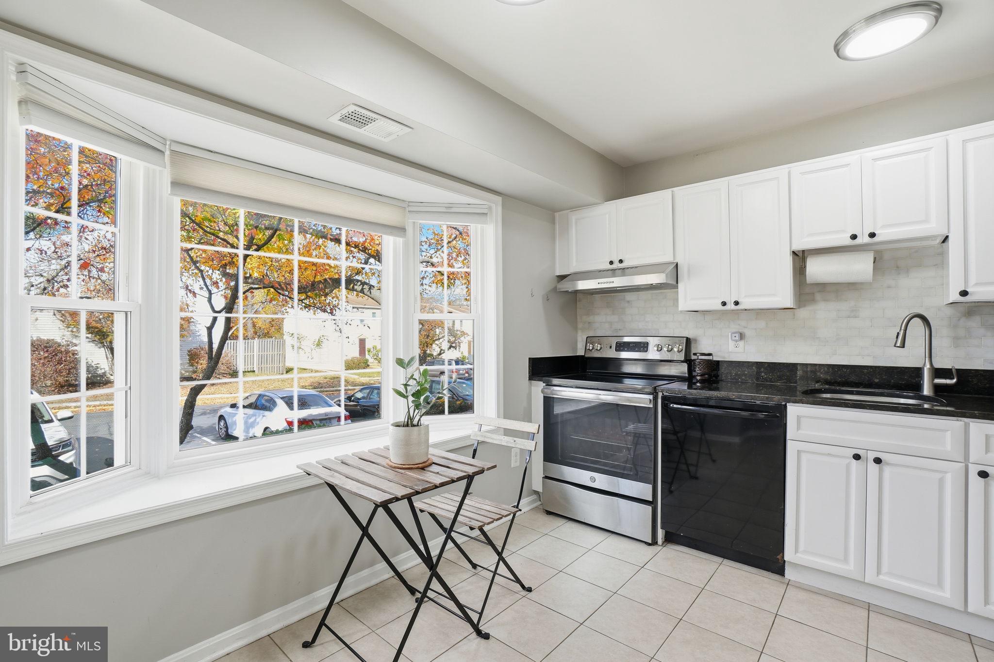 9175 Broken Oak Place, Unit 39B Burke, VA 22015 - Photo 11 of 35 a kitchen with granite countertop white cabinets and white appliances