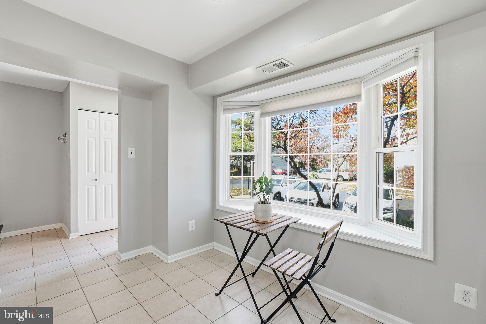 9175 Broken Oak Place, Unit 39B Burke, VA 22015 - Photo 12 of 35 a dining room with furniture and large windows