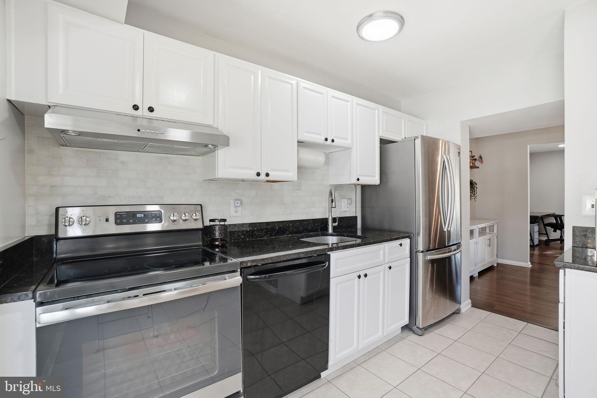 9175 Broken Oak Place, Unit 39B Burke, VA 22015 - Photo 13 of 35 a kitchen with stainless steel appliances a sink stove and refrigerator