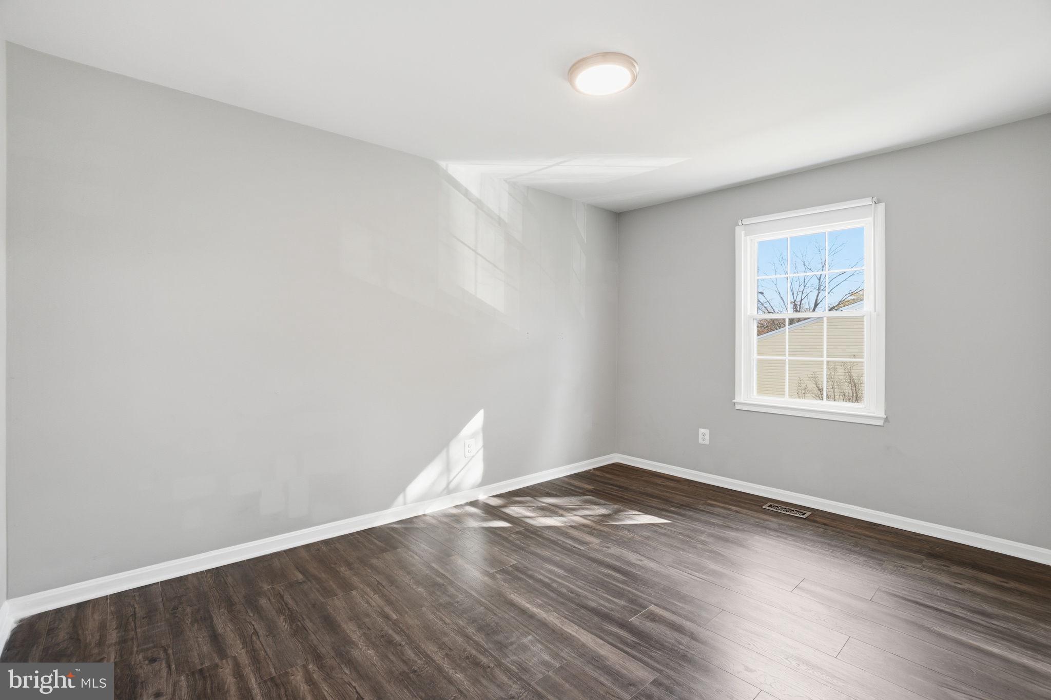 9175 Broken Oak Place, Unit 39B Burke, VA 22015 - Photo 17 of 35 an empty room with wooden floor and windows
