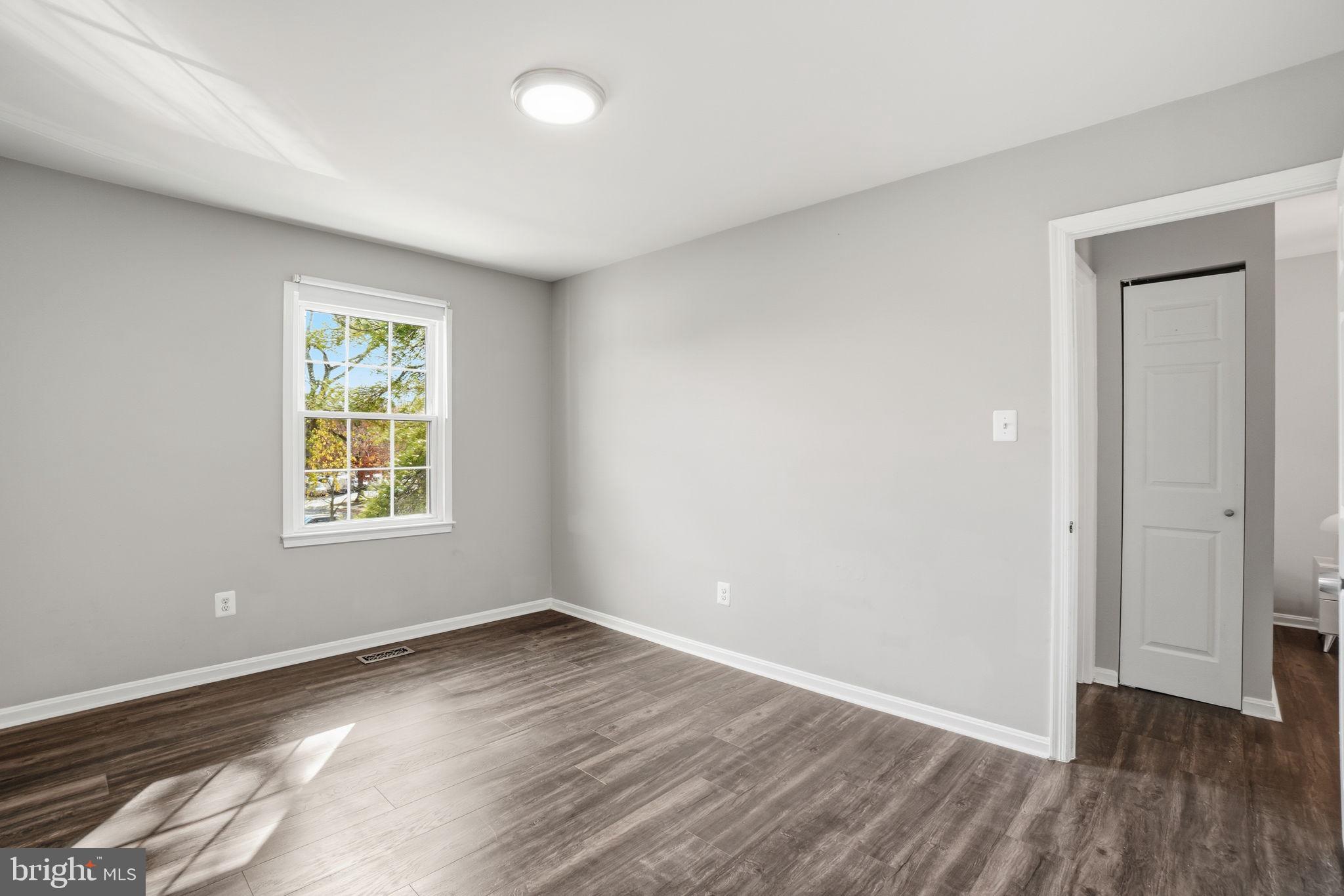 9175 Broken Oak Place, Unit 39B Burke, VA 22015 - Photo 18 of 35 an empty room with wooden floor and windows