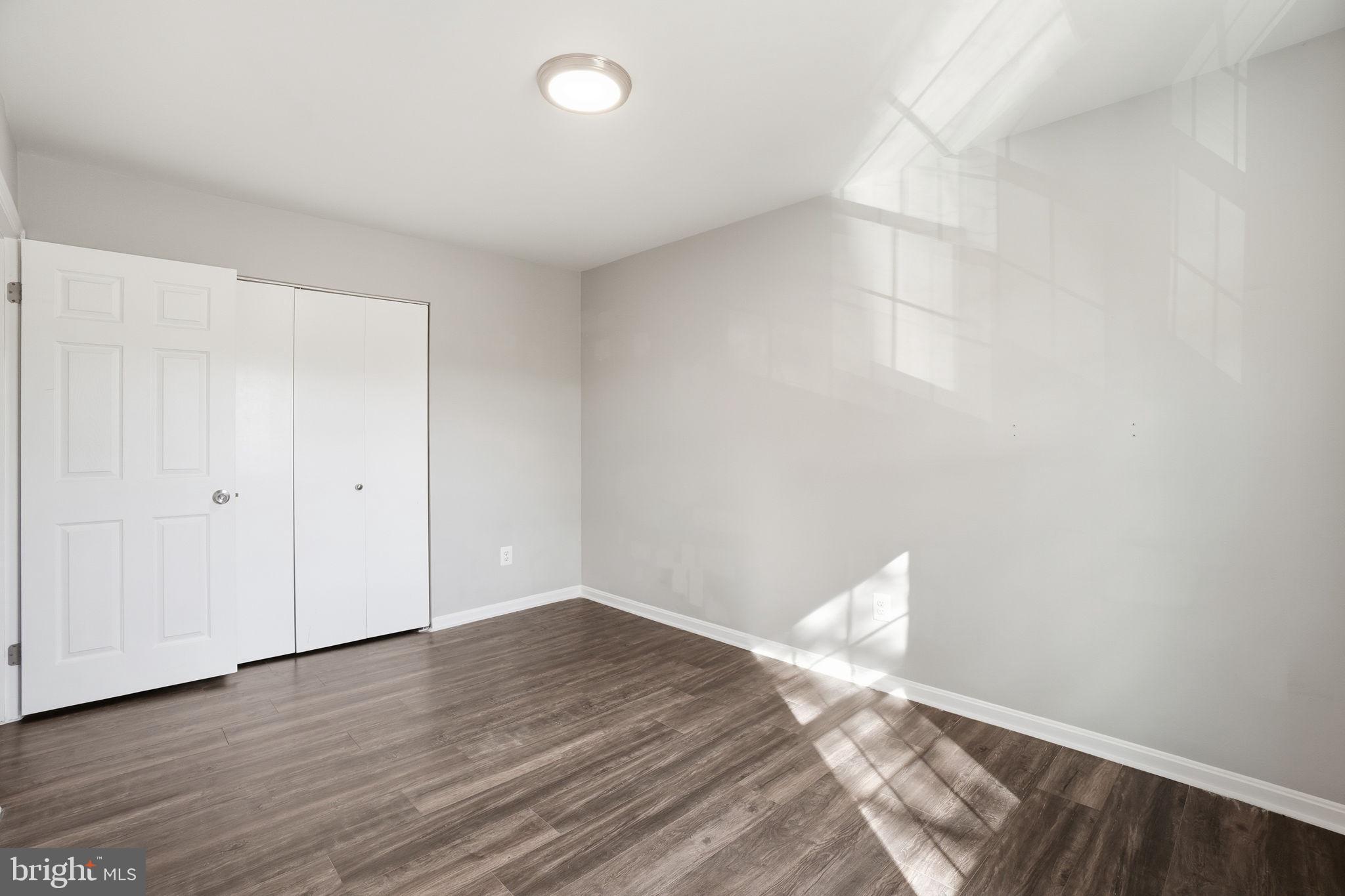 9175 Broken Oak Place, Unit 39B Burke, VA 22015 - Photo 19 of 35 a view of a room with wooden floor and white walls