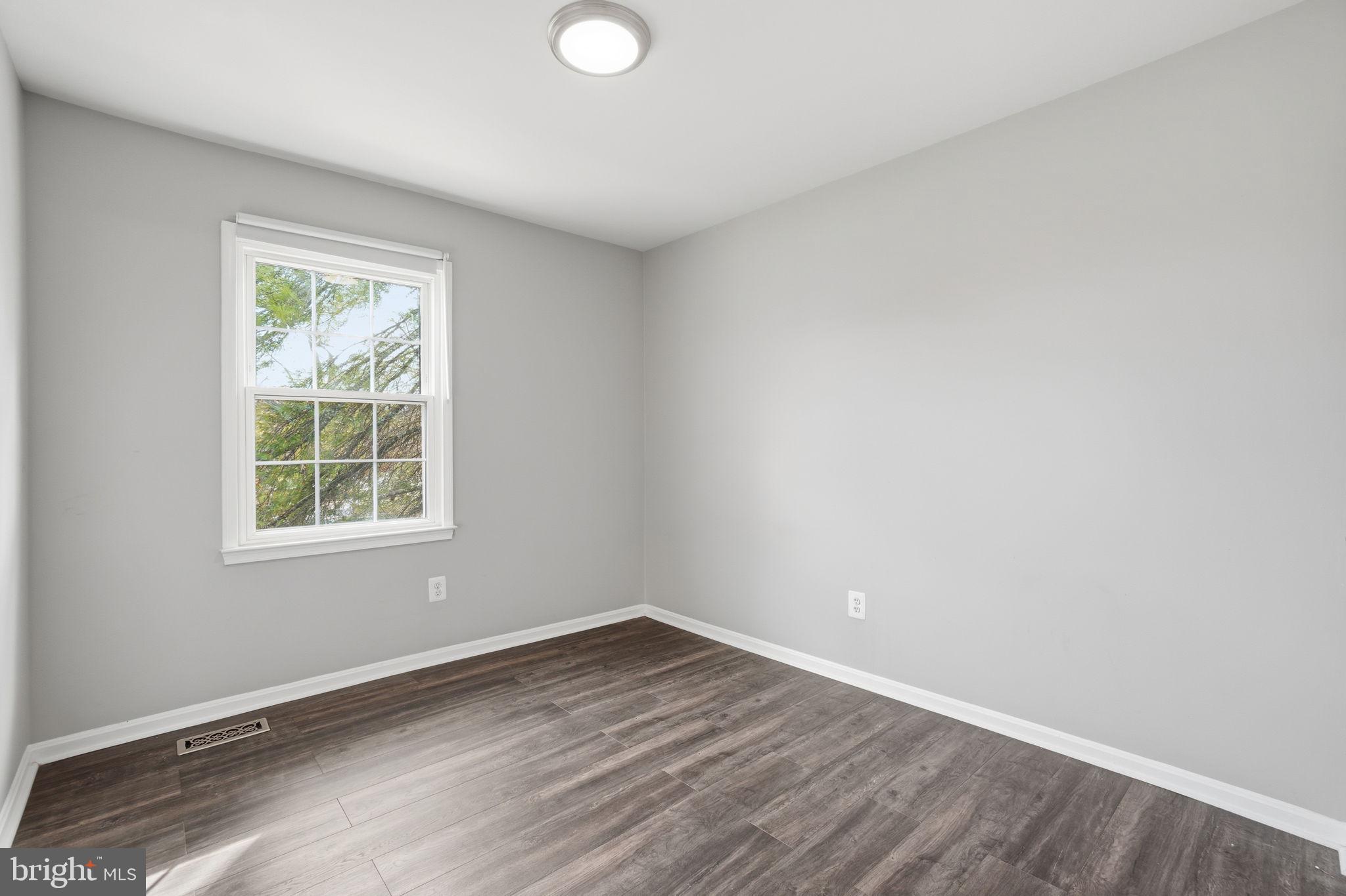 9175 Broken Oak Place, Unit 39B Burke, VA 22015 - Photo 20 of 35 an empty room with wooden floor and windows