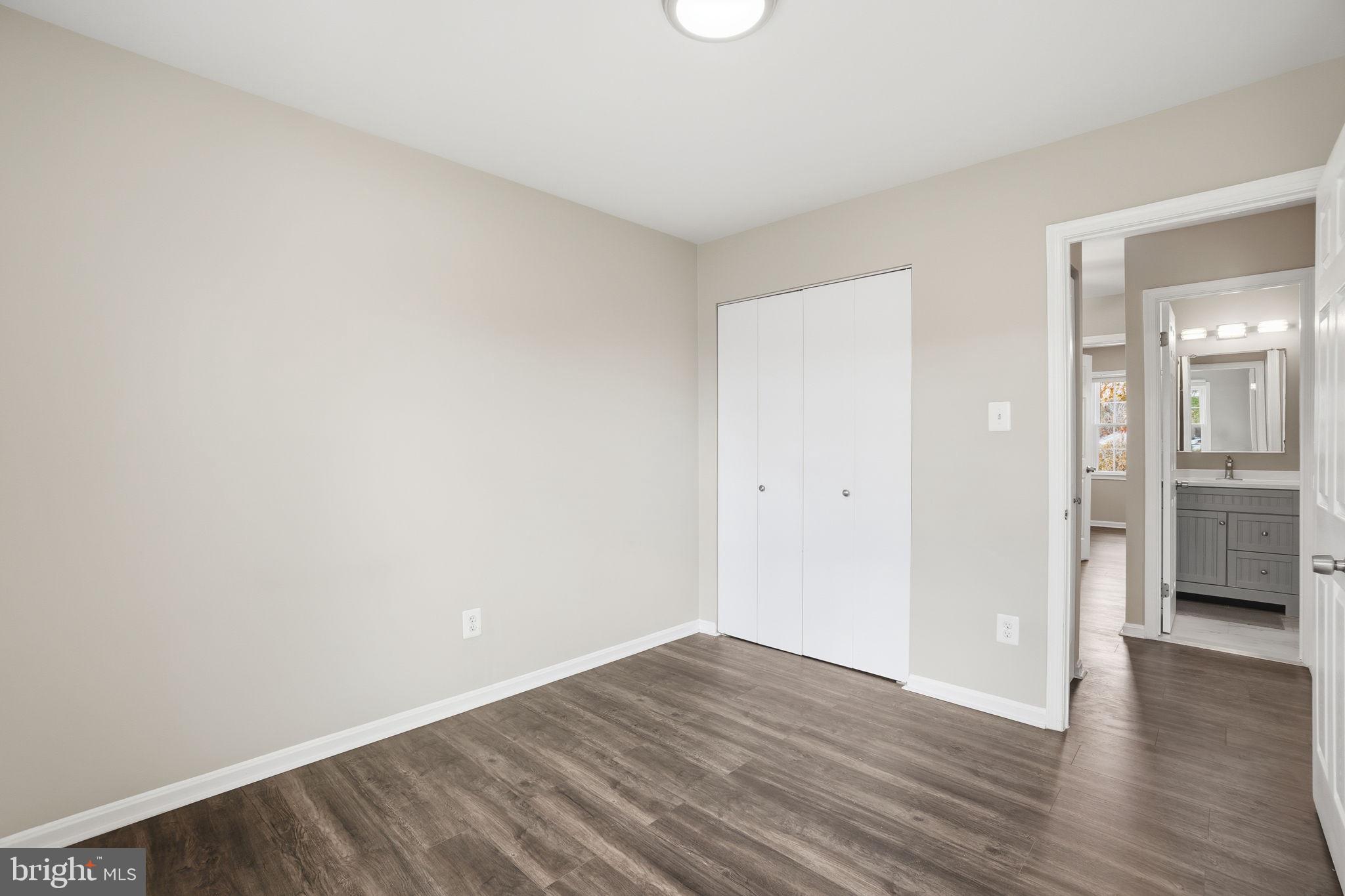9175 Broken Oak Place, Unit 39B Burke, VA 22015 - Photo 21 of 35 a view of a room with wooden floor and a bathroom