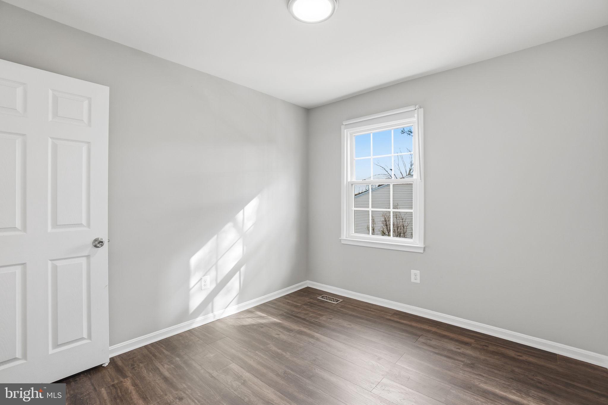 9175 Broken Oak Place, Unit 39B Burke, VA 22015 - Photo 22 of 35 a view of an empty room with wooden floor and a window