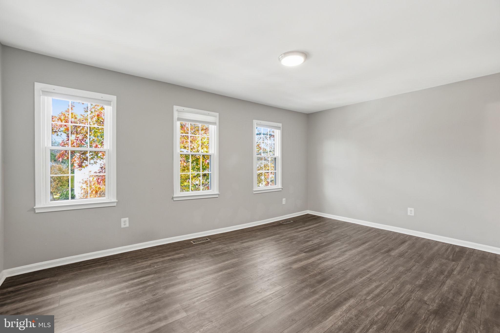 9175 Broken Oak Place, Unit 39B Burke, VA 22015 - Photo 23 of 35 an empty room with wooden floor and windows