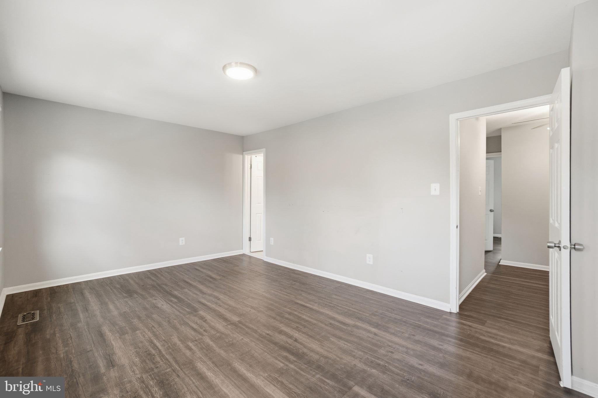 9175 Broken Oak Place, Unit 39B Burke, VA 22015 - Photo 24 of 35 a view of an empty room with wooden floor and a window